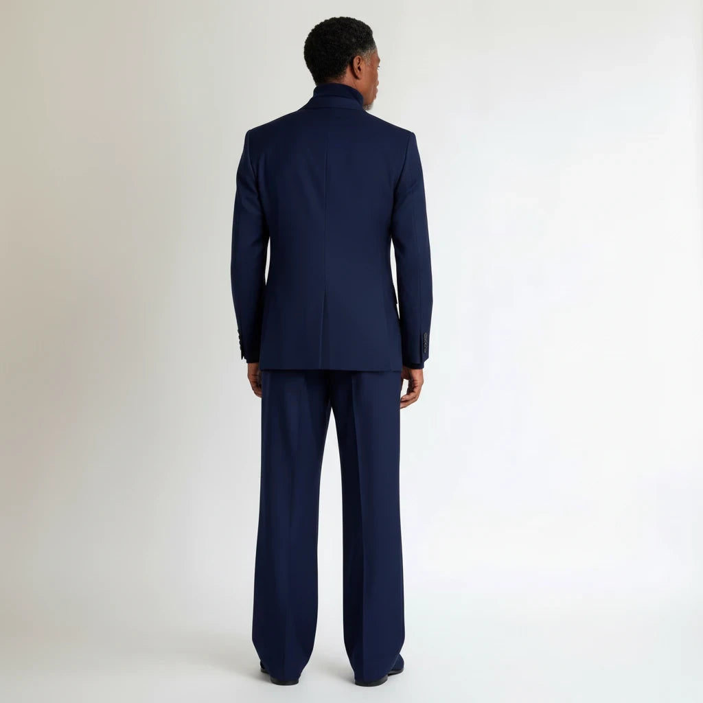 Back view of a man wearing a Terry Corbett New York navy blue wool-blend tailored suit with wide-leg trousers.