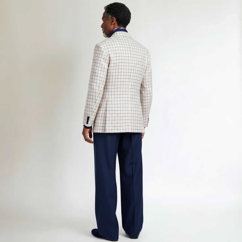 Back view of a man wearing a Terry Corbett New York beige plaid sports coat with navy trousers on a white background.