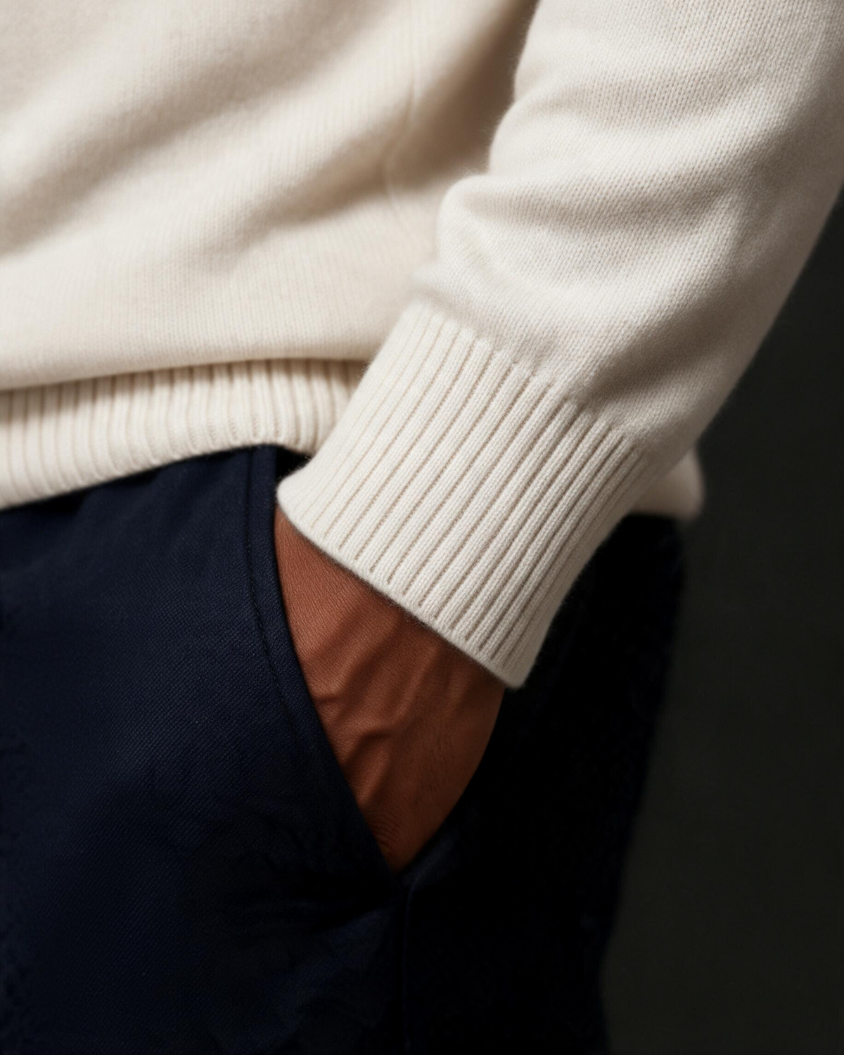 Terry Corbett New York cream cashmere turtleneck sweater featuring a ribbed cuff detail on a model