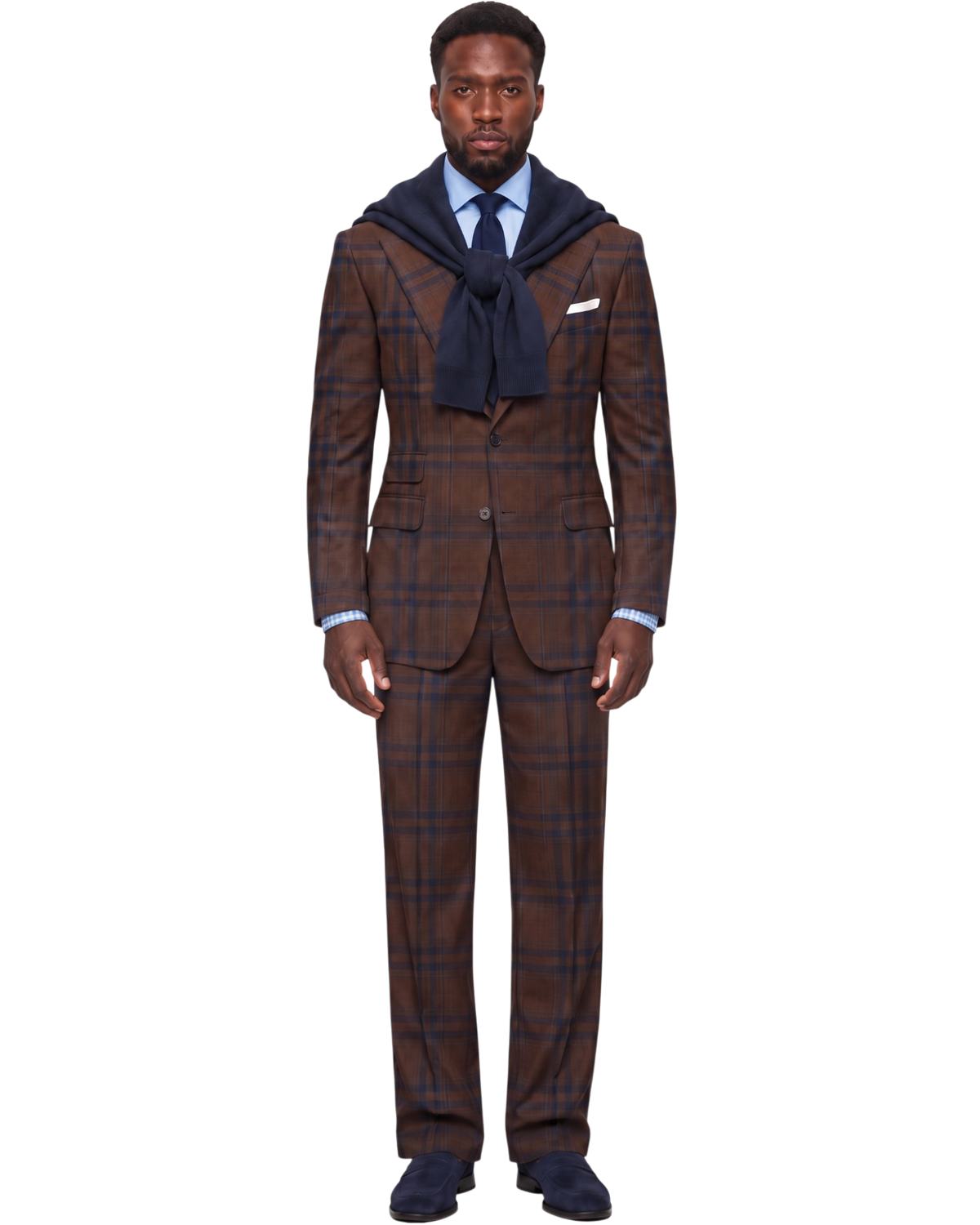 A man stands facing forward wearing a brown plaid suit with a navy blue tie, a light blue dress shirt, and a navy blue hooded scarf draped over his shoulders. The background is solid white.