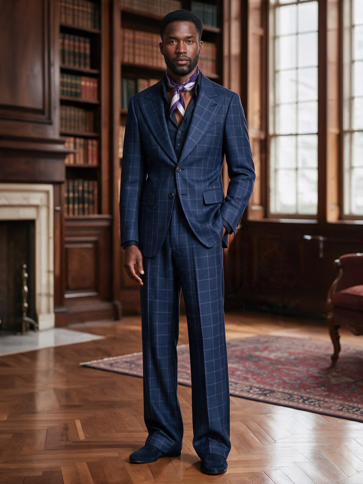 Terry Corbett New York Plaid 2 Button Peak Lapel Suit in navy windowpane plaid, standing in a library