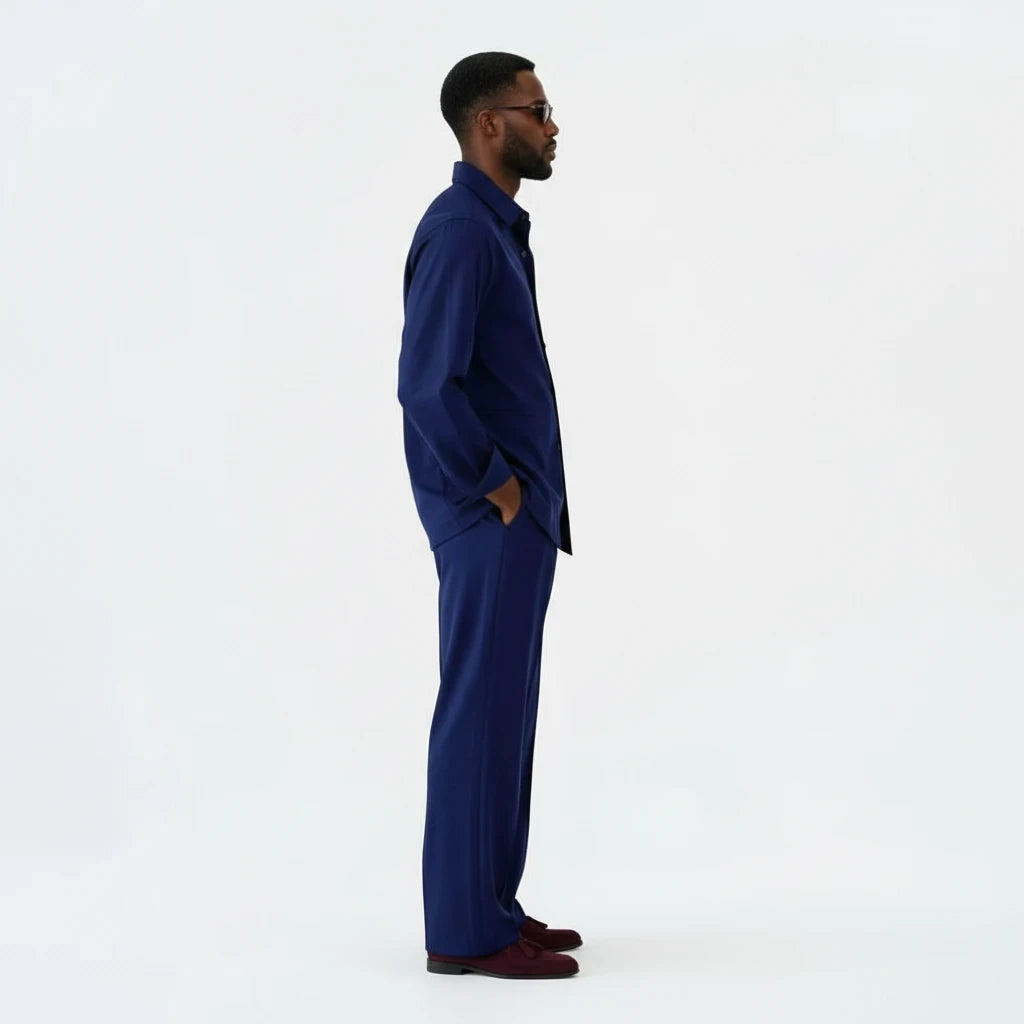 A man wearing a Terry Corbett New York deep navy button-down shirt and matching tailored trousers, side profile view.