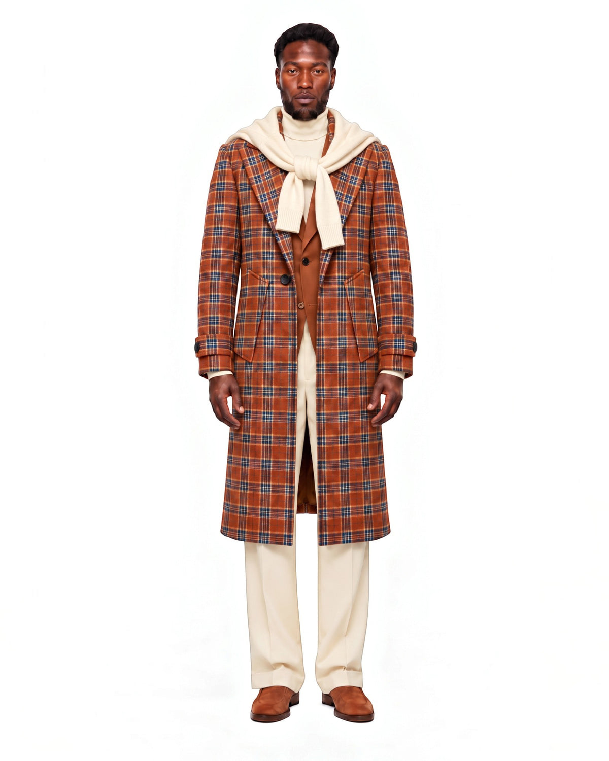 Terry Corbett New York longline wool overcoat in burnt orange and navy plaid worn by a man with a cream sweater